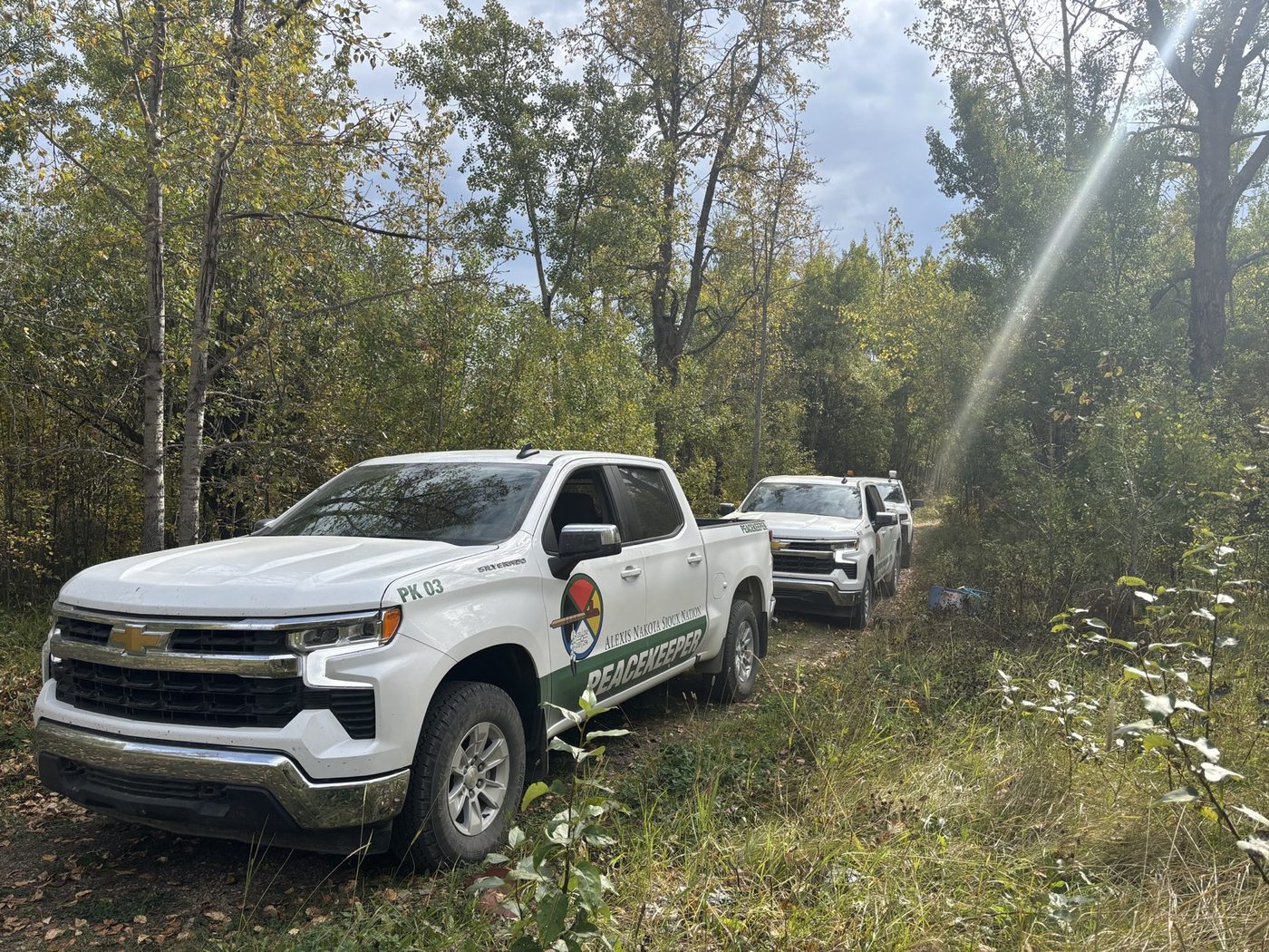 Alexis Nakota Sioux Nation Peacekeeper vehicles on a bush trail during an investigation, September 2025