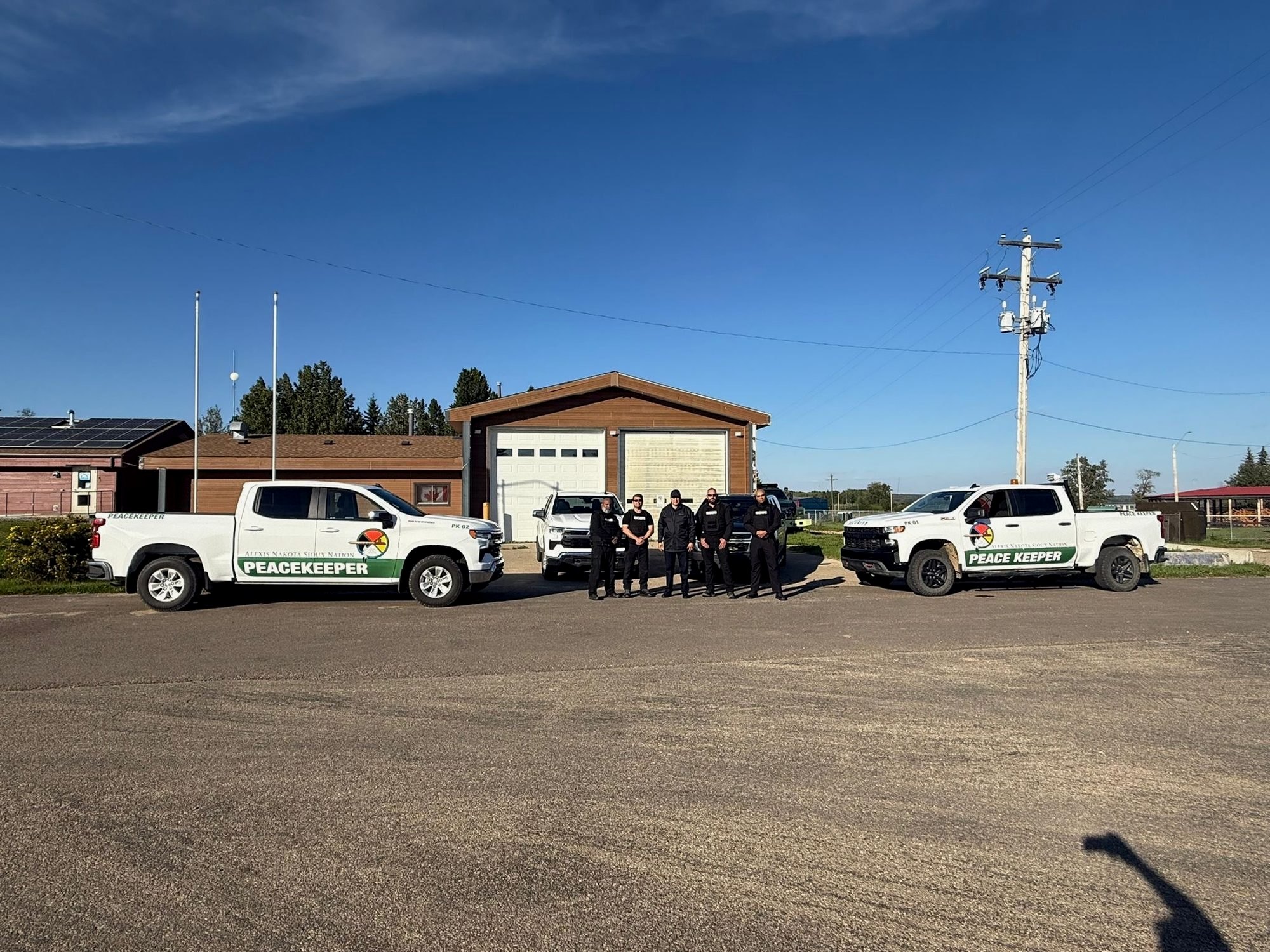 RMFC Peacekeepers with the Chief beside marked Alexis Nakota Sioux Nation Peacekeeper trucks, August 15, 2025